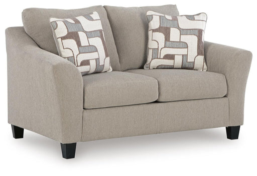 Ashley Furniture Willarae loveseat with plush fabric and cushioned armrests, shown from an angled side view.