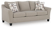 Ashley Furniture Willarae Sofa Sleeper shown in an angled view, featuring a modern design with plush cushions and wooden legs.