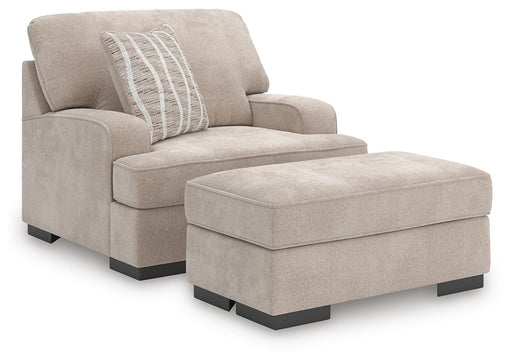 Ashley Furniture high profile chair and ottoman living room set with plush cushions and modern design.