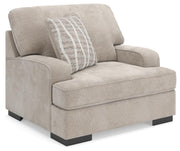 Ashley Furniture high profile living room set with chair and ottoman, featuring plush upholstery and modern design.