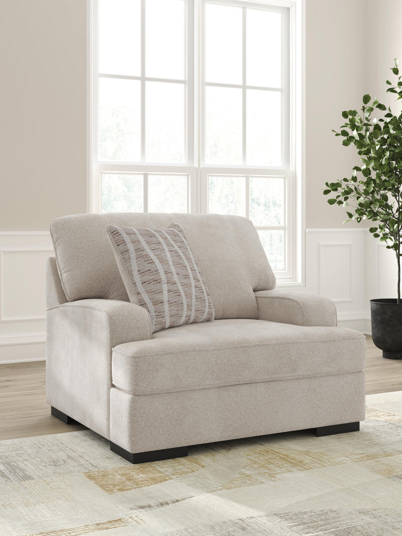 Ashley Furniture high profile living room set with chair and ottoman, featuring plush upholstery and modern design.