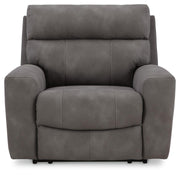 Next-Gen DuraPella Power Recliner by Ashley Furniture, close-up of plush brown fabric, padded armrests, and reclining mechanism.