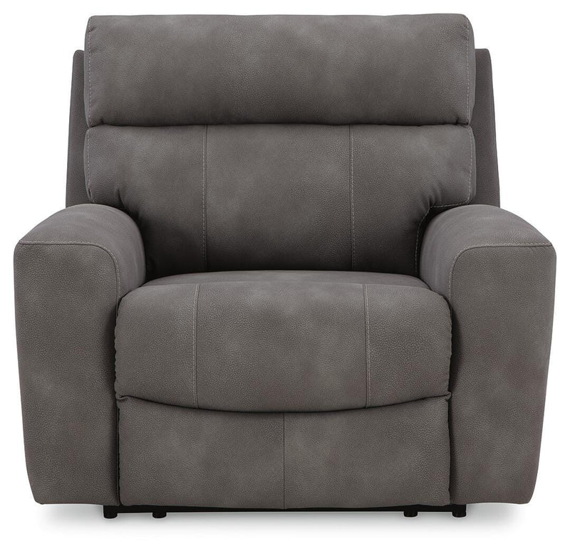 Next-Gen DuraPella Power Recliner by Ashley Furniture, close-up of plush brown fabric, padded armrests, and reclining mechanism.