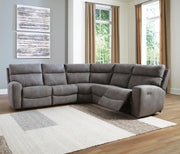 Ashley Furniture Next-Gen DuraPella power reclining sectional with plush cushions and modern design, shown in a spacious living room.