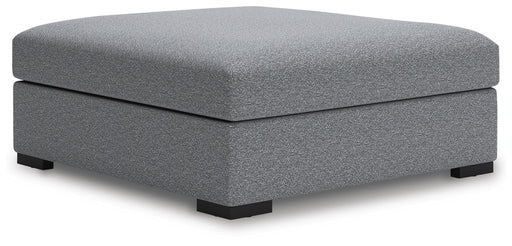 Ashley Furniture Bealton oversized accent ottoman with plush fabric and tufted top, shown from an angled side view.