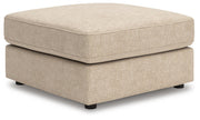 Ashley Furniture Seyler oversized accent ottoman with plush fabric and wooden legs, shown from an angled view.