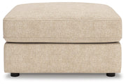 Ashley Furniture Seyler oversized accent ottoman with plush fabric and tufted top, shown in a head-on view.