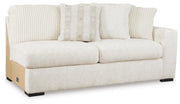 Ashley Furniture Chessington living room set shown from an angled view, includes sofa and loveseat with neutral fabric upholstery.