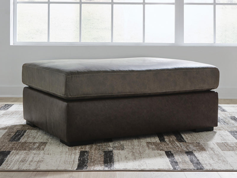 Ashley Furniture Castille Way oversized accent ottoman with plush fabric and tufted top, ideal for living room decor.