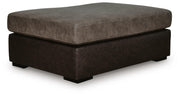 Ashley Furniture Castille Way oversized accent ottoman with plush fabric and tufted top, shown from an angled view.