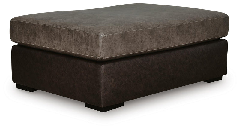 Ashley Furniture Castille Way oversized accent ottoman with plush fabric and tufted top, shown from an angled view.