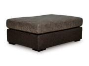 Ashley Furniture Castille Way oversized accent ottoman with neutral fabric and plush cushioned top, shown at an angle.