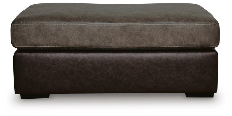Ashley Furniture Castille Way oversized accent ottoman with plush fabric and a neutral beige color, shown from a front head-on view.