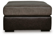 Ashley Furniture Castille Way oversized accent ottoman with plush fabric and tufted top, shown from a side angle.