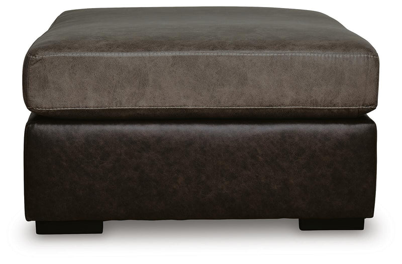 Ashley Furniture Castille Way oversized accent ottoman with plush fabric and tufted top, shown from a side angle.