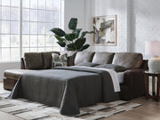 Ashley Furniture Castille Way sleeper sectional with chaise, featuring plush cushions and a modern design in neutral fabric.