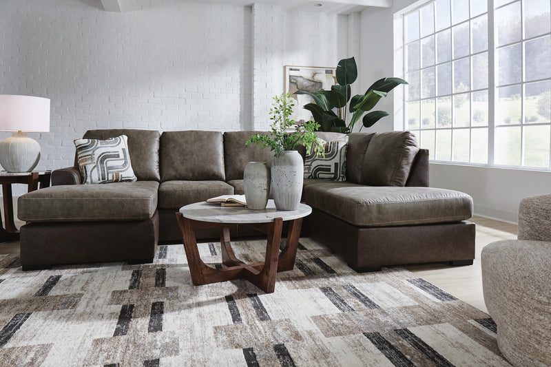 Ashley Furniture Castille Way Sleeper Sectional with chaise, beige fabric, plush cushions, and modern design in a living room setting.