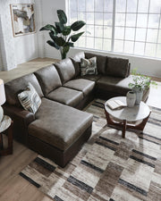 Ashley Furniture Castille Way sleeper sectional with chaise, featuring plush fabric and modern design, shown in a cozy living room setting.