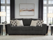 Ashley Furniture Loreo sofa with plush beige upholstery and modern design, shown in a cozy living room setting.