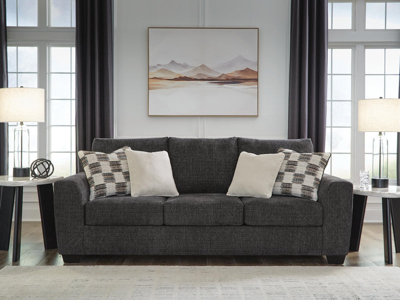 Ashley Furniture Loreo sofa with plush beige upholstery and modern design, shown in a cozy living room setting.