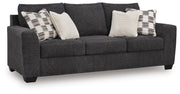 Ashley Furniture Loreo sofa with plush fabric, angled view showing comfortable cushions and modern design in a cozy living room setting.