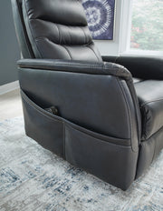 Ashley Furniture Strawbill Power Lift Recliner with padded armrests and plush upholstery, shown in a detailed close-up.