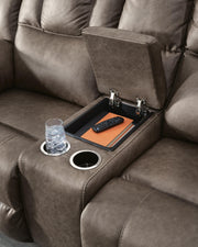 Ashley Furniture Lowilla reclining loveseat with console, showing plush fabric, built-in cup holders, and comfortable armrests.