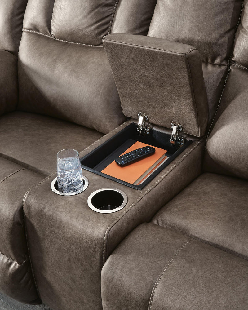 Ashley Furniture Lowilla reclining loveseat with console, showing plush fabric, built-in cup holders, and comfortable armrests.