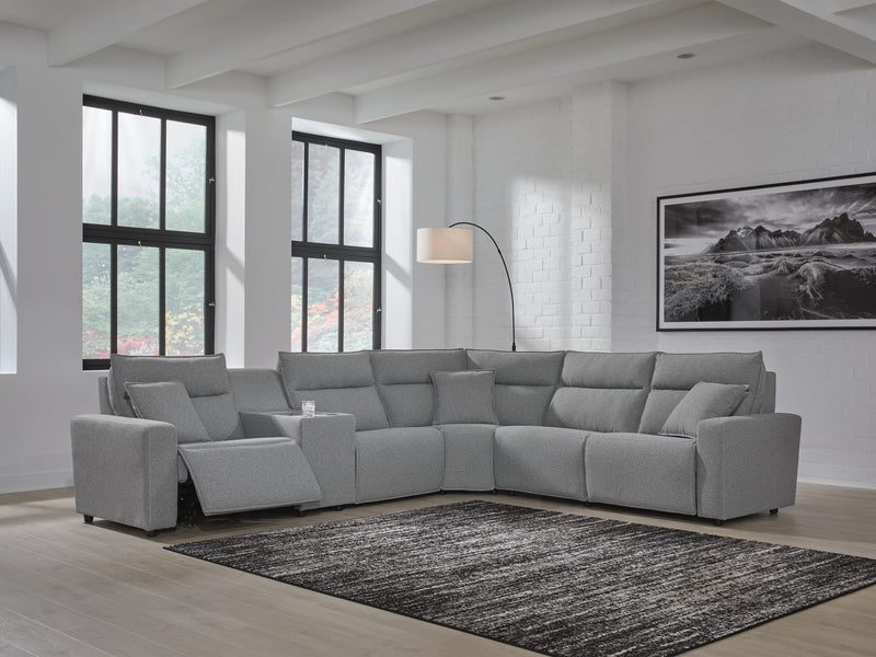 Ashley Furniture Modmax reclining sectional with built-in console, featuring plush cushions and modern design in a neutral fabric.