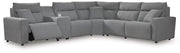 Ashley Furniture Modmax reclining sectional with built-in console, featuring plush cushions and modern design.