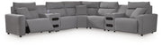 Ashley Furniture Modmax II power reclining sectional with integrated audio consoles, featuring plush cushions and modern design.