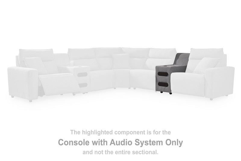 Ashley Furniture Modmax II Power Reclining Sectional with built-in audio consoles, featuring plush cushions and modern design.
