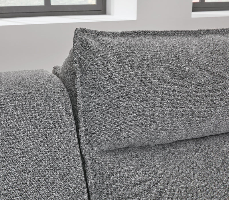 Ashley Furniture Modmax Power Reclining Sectional with detailed welt stitching and plush cushions in a contemporary living room setting.