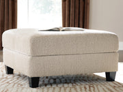Ashley Furniture Steelwater Retreat oversized accent ottoman with plush fabric and sturdy wooden legs in a modern design.