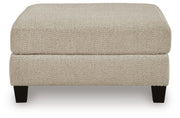 Ashley Furniture Steelwater Retreat oversized accent ottoman with plush fabric and sturdy wooden legs, shown in a head-on view.