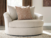 Ashley Furniture Steelwater Retreat oversized swivel accent chair with plush upholstery and wooden legs, shown in a stylish living room setting.