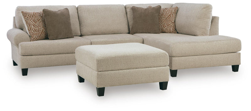 Ashley Furniture Steelwater Retreat living room set with sofa and armchair, featuring neutral fabric upholstery and decorative cushions.
