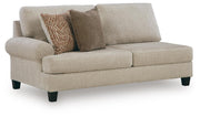 Ashley Furniture Steelwater Retreat sectional with chaise, showing beige fabric upholstery and modern living room corner setting.