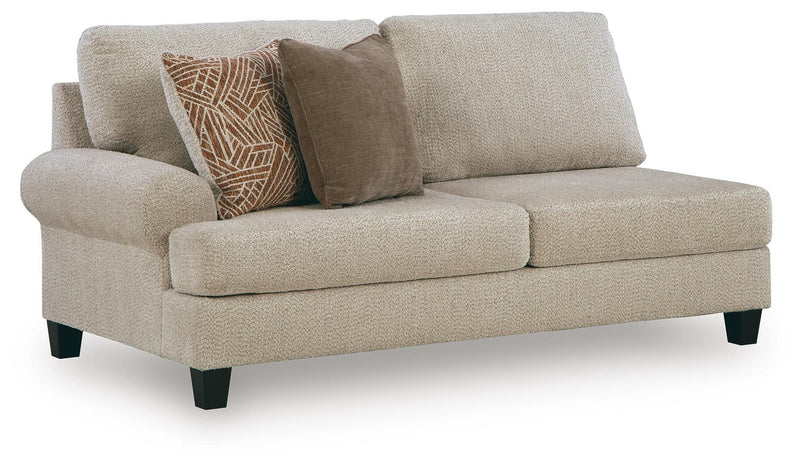 Ashley Furniture Steelwater Retreat sectional with chaise, showing beige fabric upholstery and modern living room corner setting.
