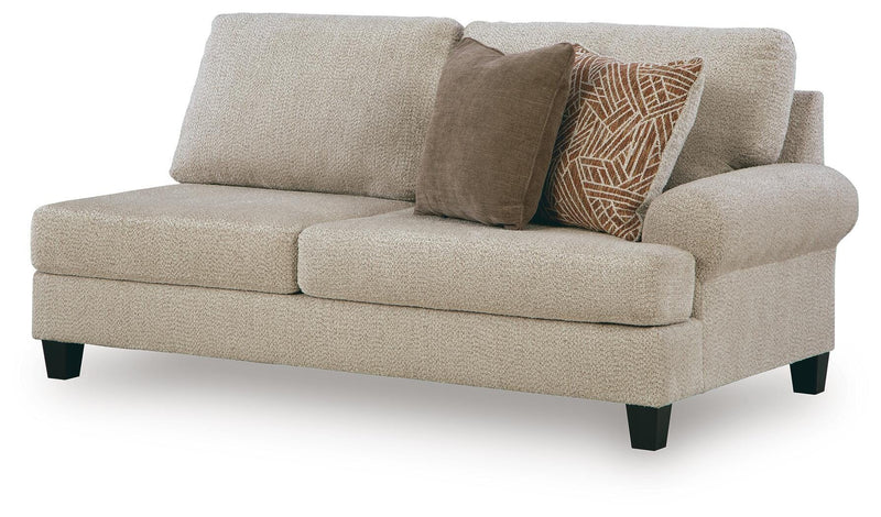Ashley Furniture Steelwater Retreat sectional with chaise, showing a modern fabric sofa with cushions and a chaise lounge in neutral tones.