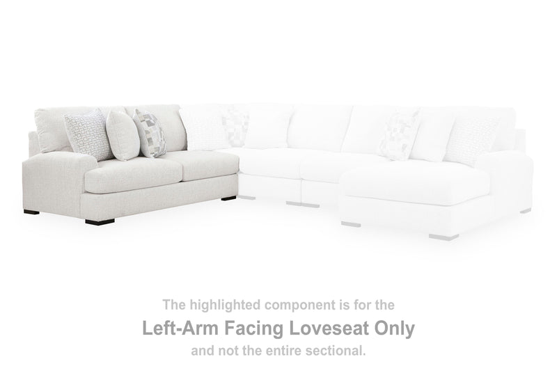 Ashley Furniture Misty-Lakes sectional with chaise, featuring neutral fabric and plush cushions in a modern living room setting.