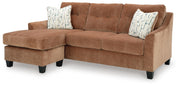 Ashley Furniture Amity Bay sofa chaise, chofa with plush cushions and wooden legs, shown from an angled side view.