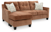 Ashley Furniture Amity Bay sofa chaise sleeper with plush fabric, angled view showing the extended chaise and cozy sleeping area.