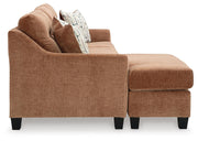 Ashley Furniture Amity Bay sofa chofa with chaise, featuring plush cushions and a modern design, shown from the side.