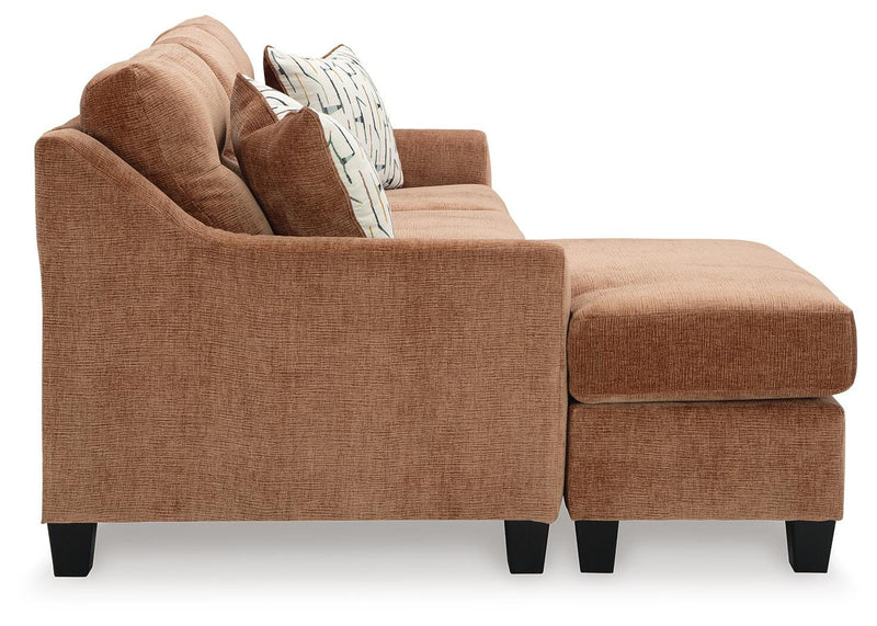 Ashley Furniture Amity Bay sofa chofa with chaise, featuring plush cushions and a modern design, shown from the side.