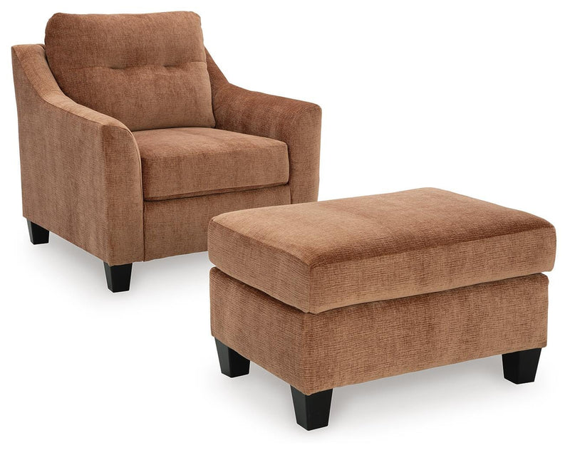 Ashley Furniture Amity Bay living room set with sofa and armchair, shown from a side angle in a cozy living space setting.