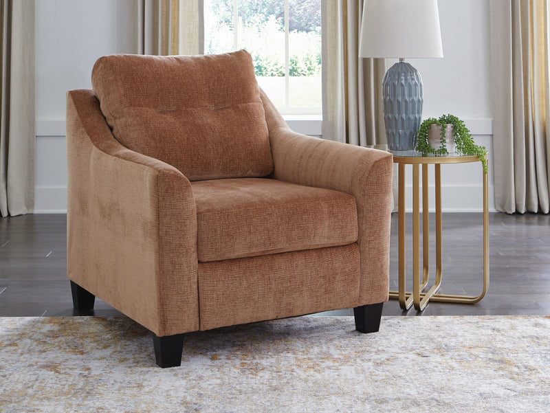 Ashley Furniture Amity Bay Chair with cushioned seat and wooden legs, showcasing a stylish and comfortable living room accent piece.