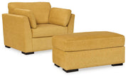 Ashley Furniture Keerwick living room set featuring a sofa, loveseat, and armchair with neutral upholstery and modern design.