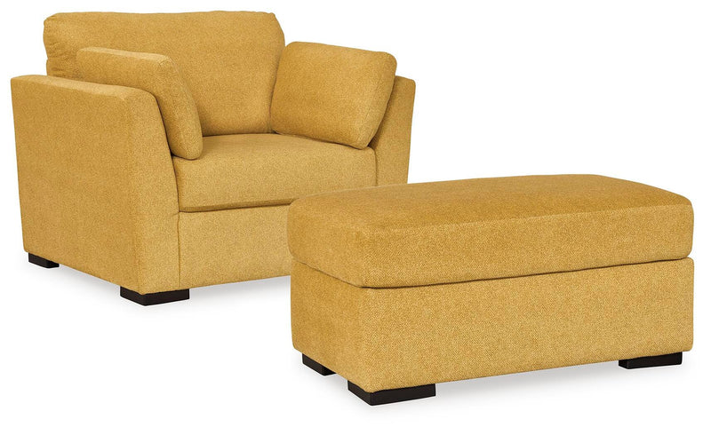 Ashley Furniture Keerwick living room set featuring a sofa, loveseat, and armchair with neutral upholstery and modern design.