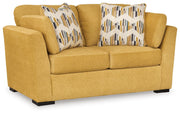 Ashley Furniture Keerwick living room set featuring a sofa and armchair in a modern design with neutral upholstery.